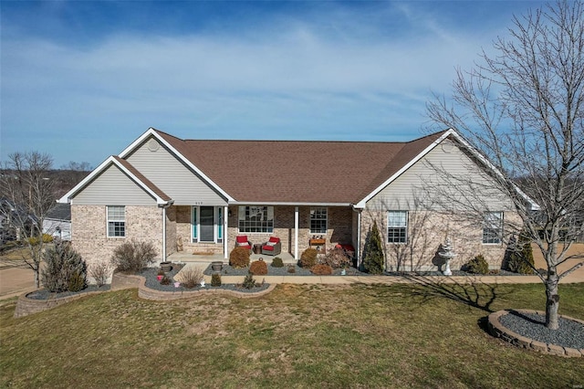 ranch-style house with covered porch and a front lawn