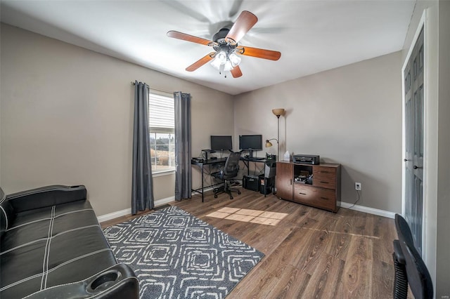 home office with dark wood-type flooring and ceiling fan