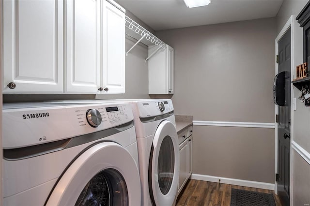 laundry area with cabinets, dark wood-type flooring, and independent washer and dryer