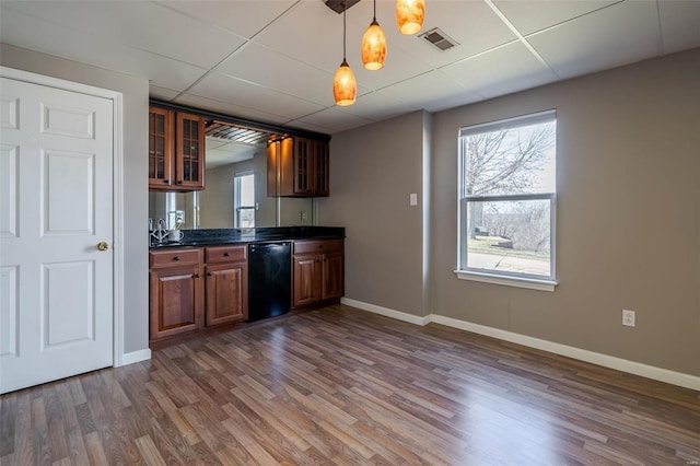 kitchen with dark hardwood / wood-style flooring, decorative light fixtures, a paneled ceiling, and dishwasher