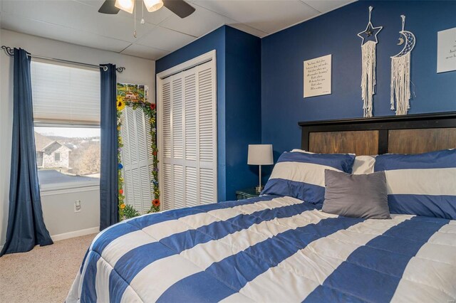 bedroom with ceiling fan, a closet, and carpet