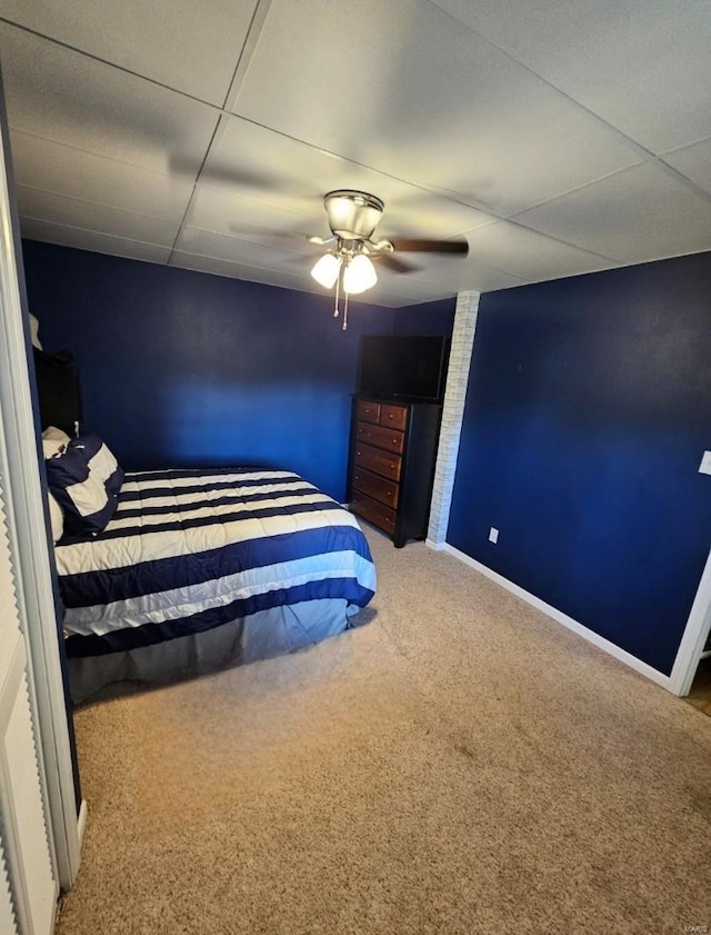 bedroom featuring carpet, a paneled ceiling, and ceiling fan