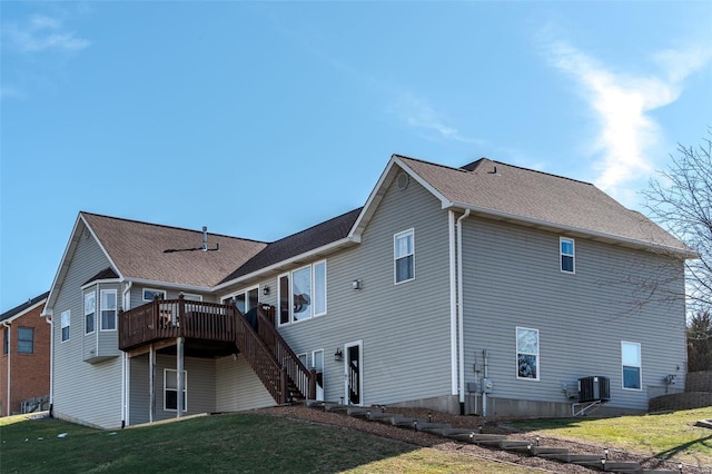 back of property featuring a yard, central AC unit, and a deck