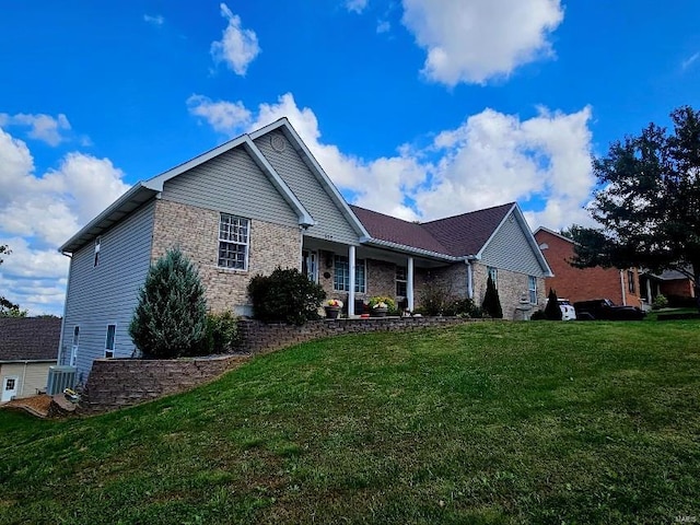 view of front of home featuring a front lawn and central air condition unit