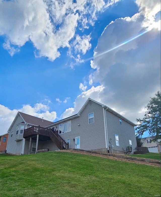 back of house with a yard and a deck