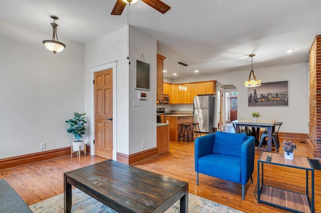 living room featuring light hardwood / wood-style flooring and ceiling fan