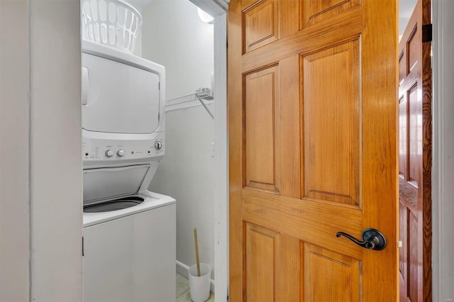 clothes washing area featuring stacked washer and dryer