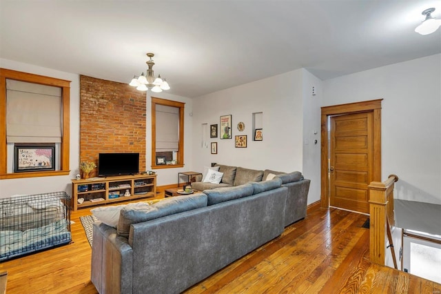 living room with hardwood / wood-style floors and a notable chandelier