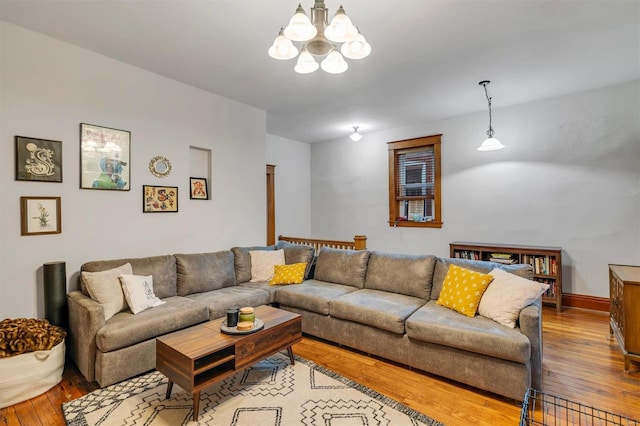 living room featuring a chandelier and light wood-type flooring