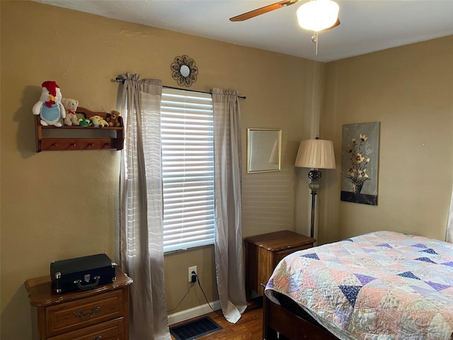 bedroom with wood-type flooring and ceiling fan