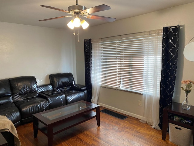 living room featuring wood-type flooring and ceiling fan