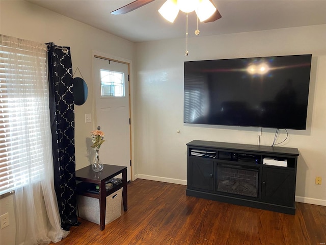 living room with ceiling fan and dark hardwood / wood-style floors