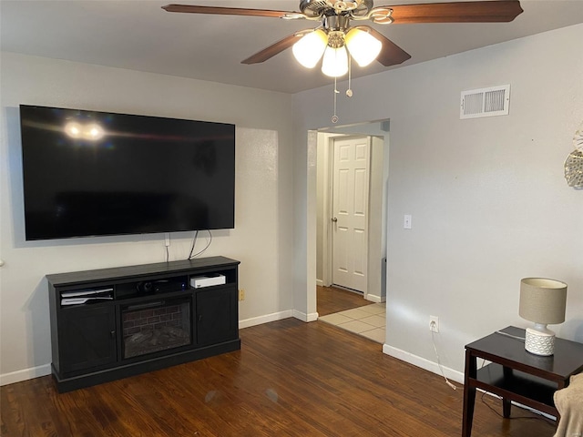 living room with ceiling fan and wood-type flooring