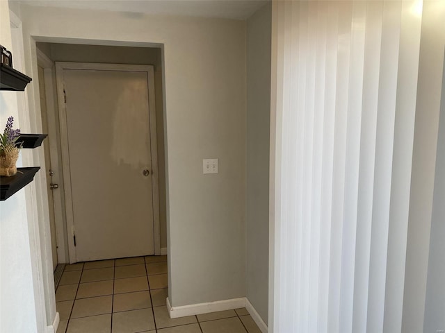 hall featuring light tile patterned flooring