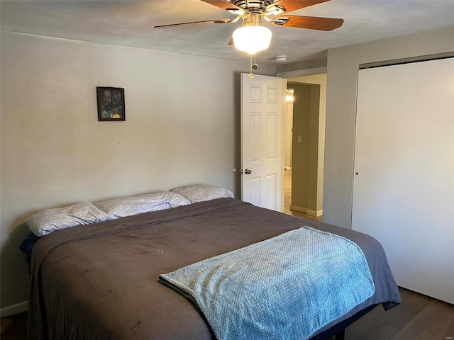 bedroom with wood-type flooring, a closet, and ceiling fan