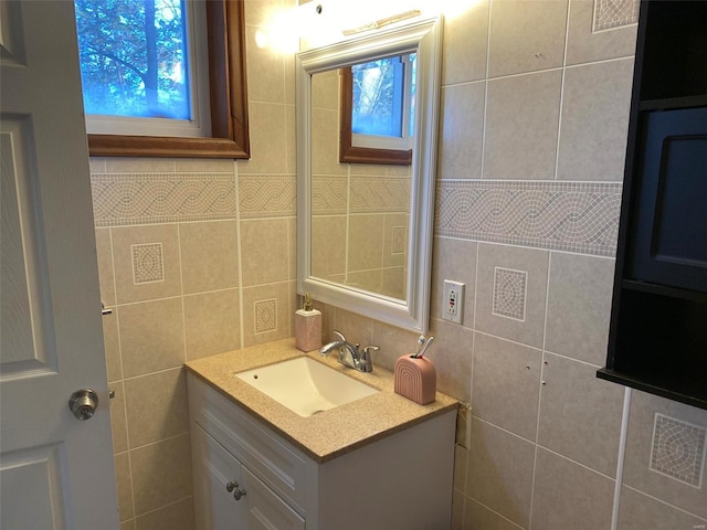 bathroom with tile walls and vanity