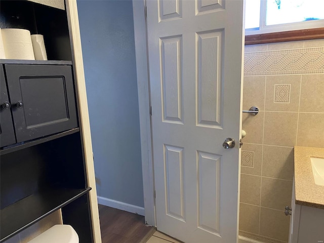 bathroom featuring hardwood / wood-style flooring, vanity, and toilet