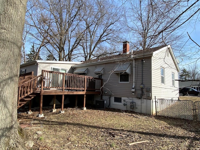 rear view of property featuring central air condition unit and a deck