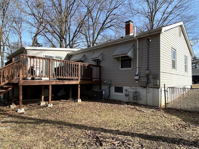 back of property with cooling unit and a deck