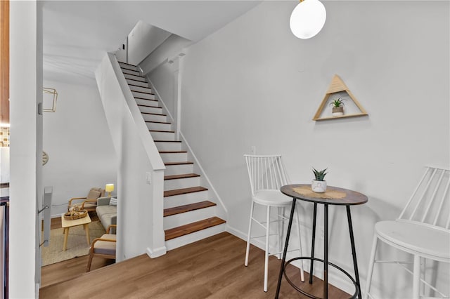 stairs featuring hardwood / wood-style floors