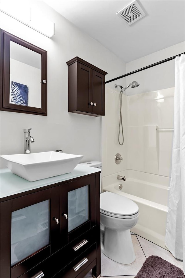 full bathroom featuring vanity, shower / bathtub combination with curtain, tile patterned floors, and toilet