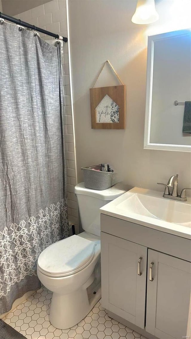 bathroom featuring vanity, toilet, and a shower with shower curtain