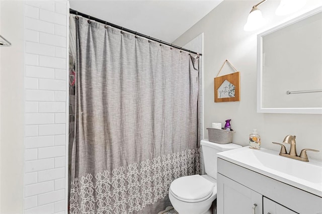 bathroom with toilet, a shower with shower curtain, and vanity