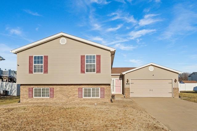 tri-level home featuring a garage and a front yard