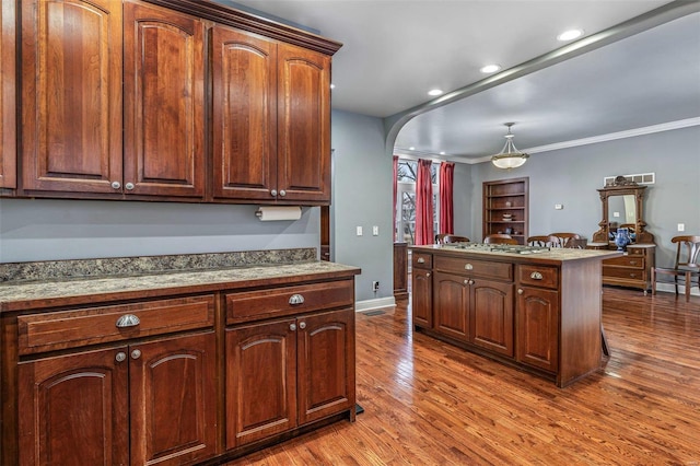 kitchen with ornamental molding and hardwood / wood-style floors