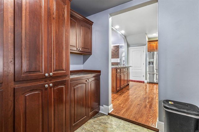 kitchen featuring stainless steel refrigerator with ice dispenser