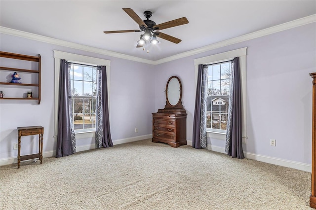 interior space with crown molding, a wealth of natural light, ceiling fan, and carpet