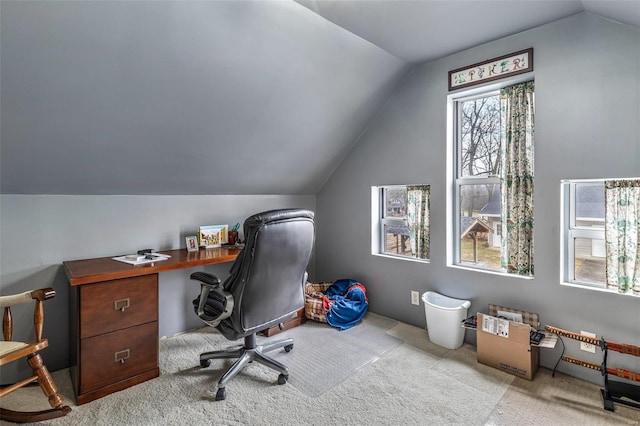 office with lofted ceiling and light colored carpet