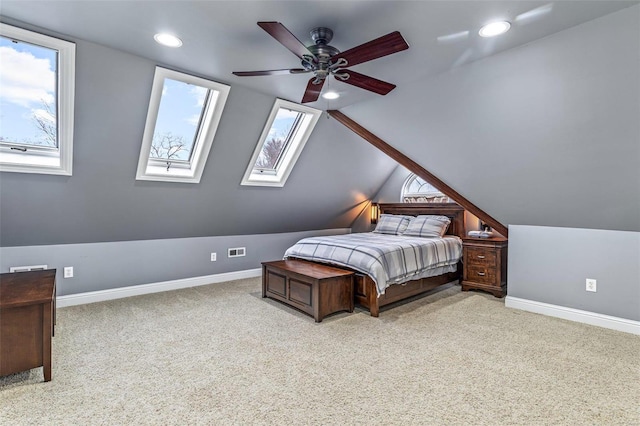 bedroom with lofted ceiling, multiple windows, light colored carpet, and ceiling fan