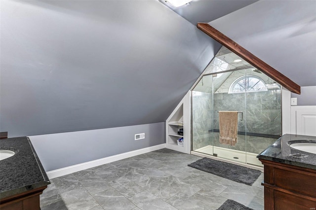 bathroom with built in shelves, vanity, an enclosed shower, and vaulted ceiling