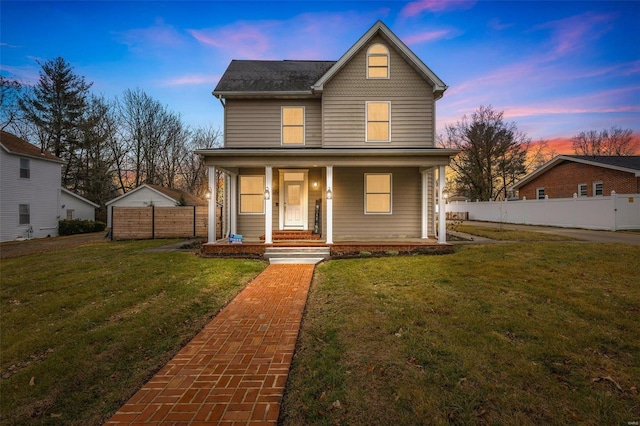 view of front of house featuring a yard and covered porch