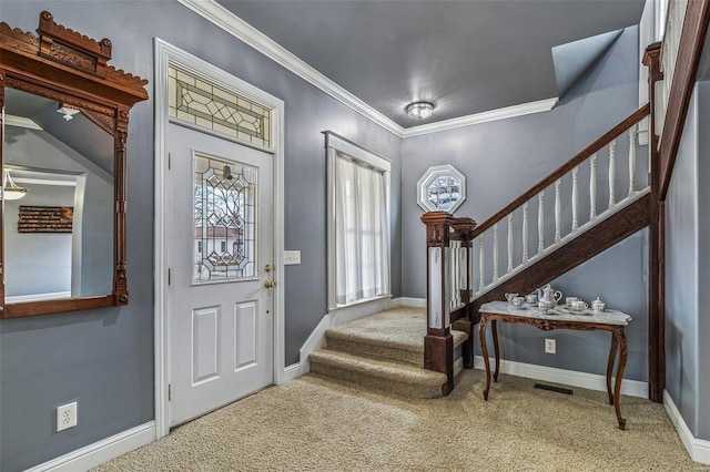 entrance foyer with ornamental molding and carpet