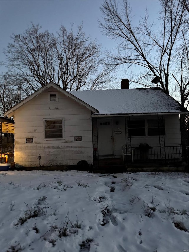 view of snow covered house