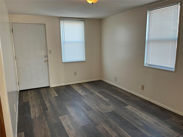 empty room with dark hardwood / wood-style floors