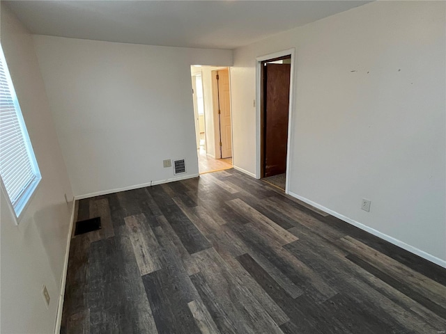 unfurnished room featuring dark hardwood / wood-style flooring