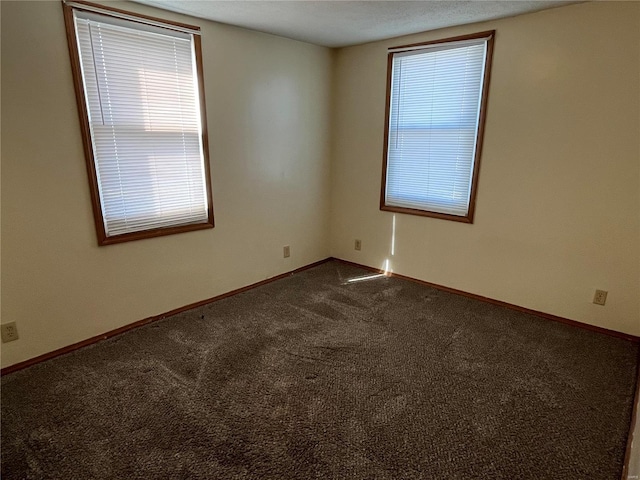 empty room featuring dark colored carpet