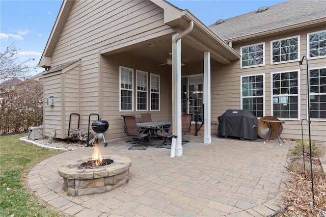 view of patio / terrace featuring area for grilling, a fire pit, and ceiling fan