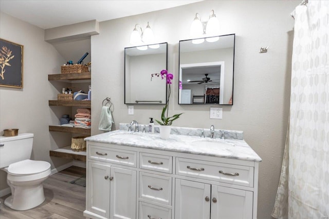 bathroom featuring vanity, ceiling fan, wood-type flooring, and toilet