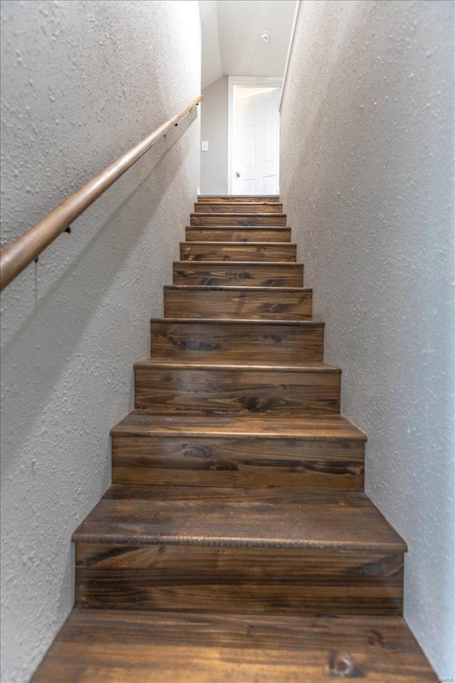 staircase with lofted ceiling