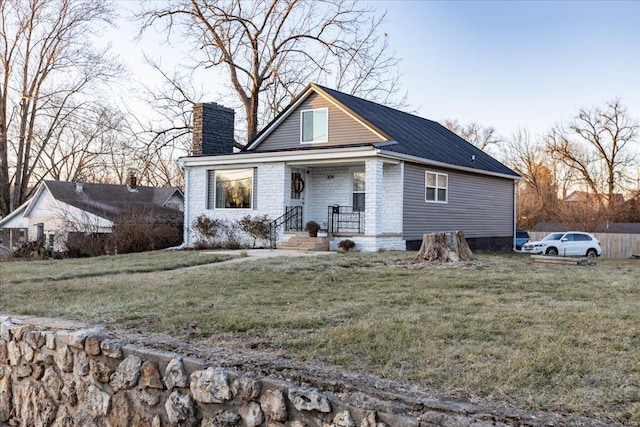 view of front of home with covered porch and a front yard