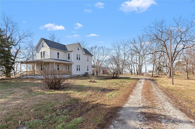 view of property exterior with central air condition unit and a porch