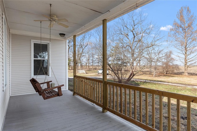 wooden deck featuring a porch and ceiling fan