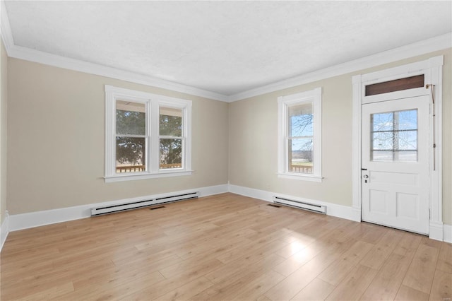 entryway featuring crown molding, a baseboard heating unit, and light hardwood / wood-style floors