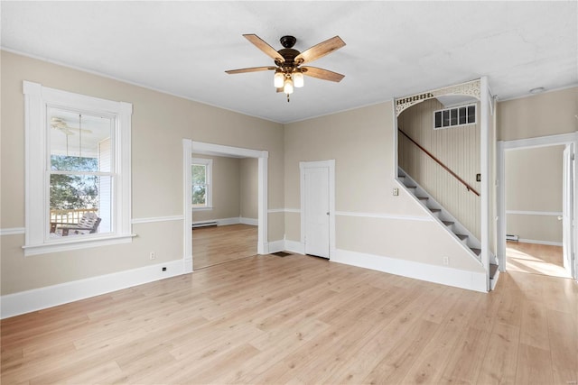 unfurnished room featuring ceiling fan, light wood-type flooring, and baseboard heating