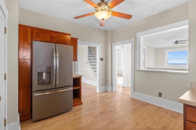 kitchen featuring ceiling fan, light hardwood / wood-style floors, and stainless steel fridge with ice dispenser