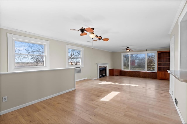 unfurnished living room with crown molding and light wood-type flooring